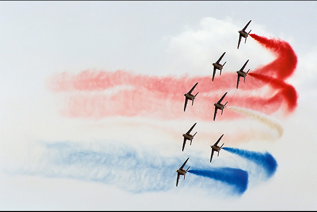 Patrouille de France jets trailing red white and blue display smoke