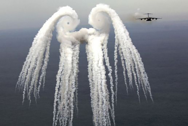 C-17 Globemaster releasing infrared countermeasure flares forming the famous smoke angel pattern