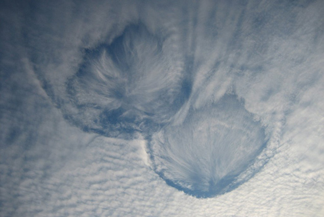 Two round fallstreak holes in an altocumulus cloud sheet